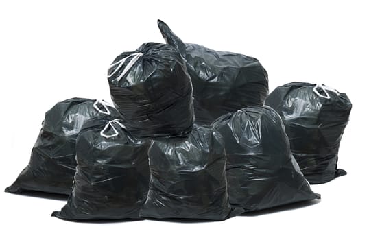 Group of green trash bags isolated on a white background.