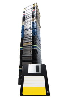 Vertical pile of computer floppy disks isolated on a white background.