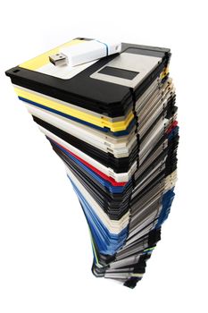 Vertical pile of computer floppy disks with usb disk isolated on a white background.