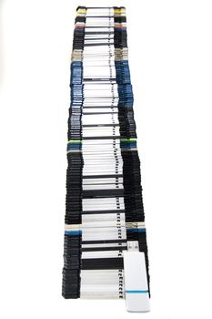 Vertical pile of computer floppy disks with usb disk isolated on a white background.