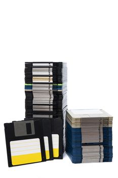 Vertical pile of computer floppy disks isolated on a white background.