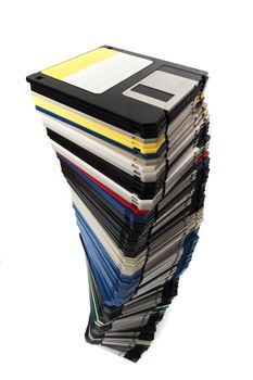 Vertical pile of computer floppy disks isolated on a white background.