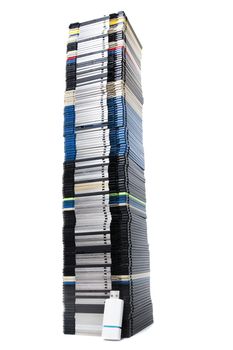 Vertical pile of computer floppy disks with usb disk isolated on a white background.