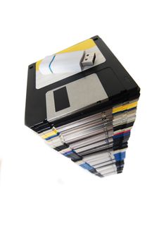 Vertical pile of computer floppy disks with usb disk isolated on a white background.