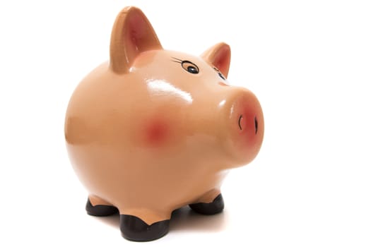Close up view of a cute pink piggy bank isolated on a white background.