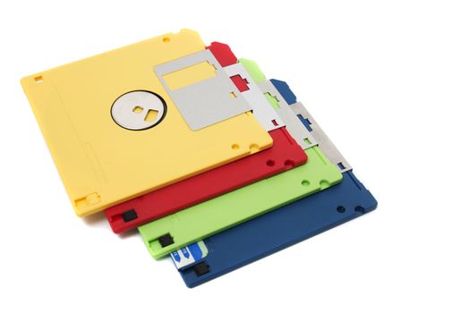 Pile of colorful computer floppy disks isolated on a white background.