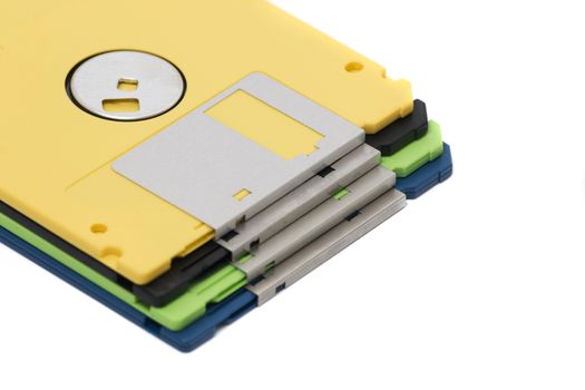 Pile of colorful computer floppy disks isolated on a white background.