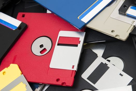 mixed pile of obselete computer floppy disks.