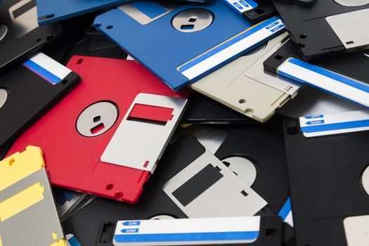 mixed pile of obselete computer floppy disks.