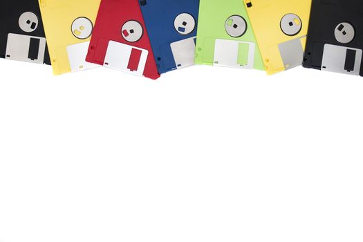 row of colorful computer floppy disks isolated on a white background.