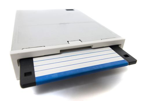 Closeup view of a computer floppy drive, isolated on a white background.