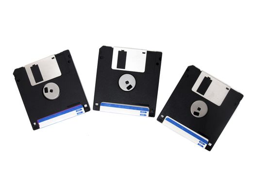 three computer floppy disks on a composition isolated on a white background.