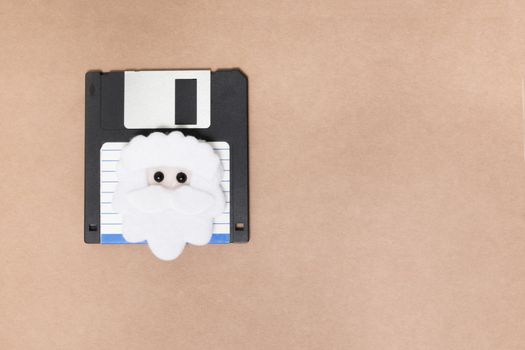 old floppy disk concept isolated on a brown background.
