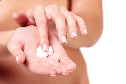 Closeup shot of beautiful woman's hands with cream, isolated on white background