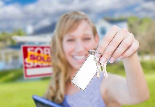 Woman Holding New House Keys with Blank Card In Front of Sold Real Estate Sign and Home.