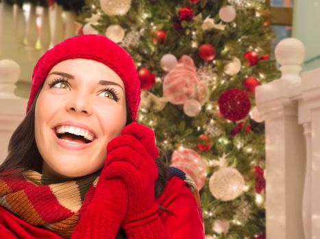 Warmly Dressed Female In Front of Decorated Christmas Tree.