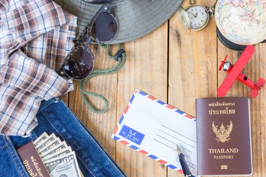 jeans, shirt, passports, banknote, sunglasses, airplane model, pocket watch, fountain pen and envelope of cost of travel prepared for the trip, Travel accessorie costumer.