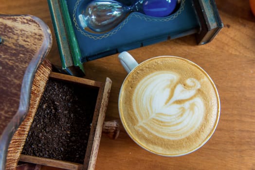 latte art coffee or cappuccino on wooden table background.