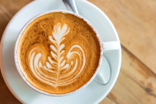 latte art coffee or cappuccino on wooden table background.