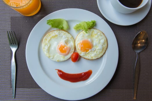 Happy Face Frying Eggs with coffee for breakfast.