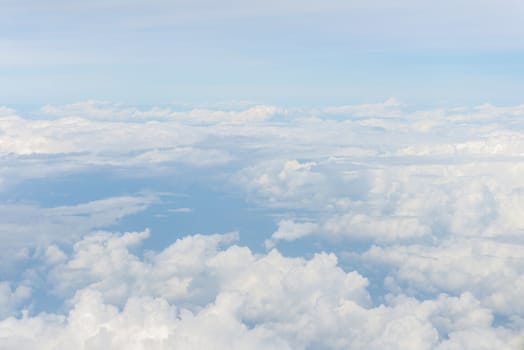 Blue sky and Clouds as seen through window of aircraft.