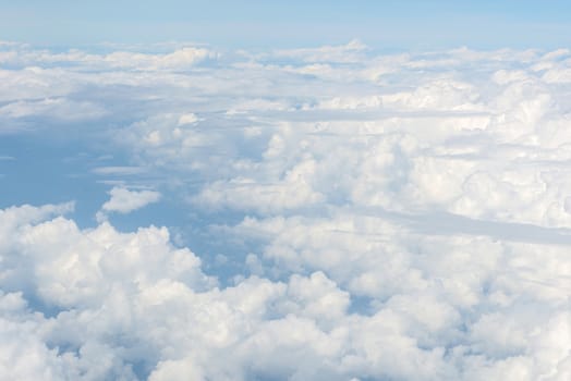 Blue sky and Clouds as seen through window of aircraft.