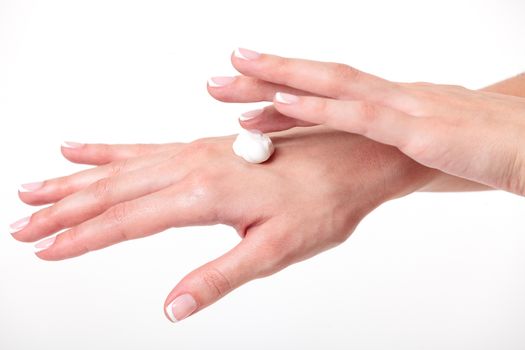 Closeup shot of beautiful woman's hands with cream, white background