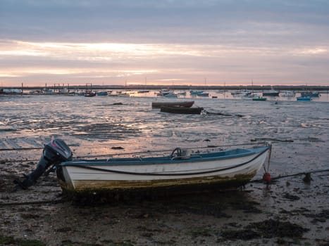 sun set sky dramatic clouds sea front beach harbor marina boats moored landscape; west mersea, essex, england, uk