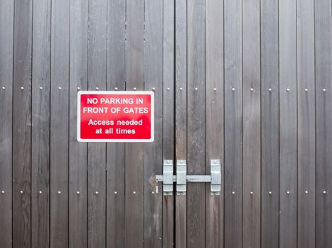 no parking in front of gates access needed at all times red parking sign; essex; england; uk