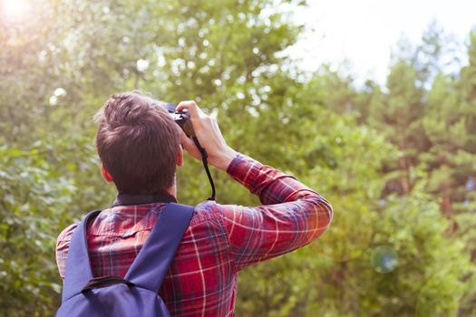 A young man takes photos of nature. Summer-Autumn.
