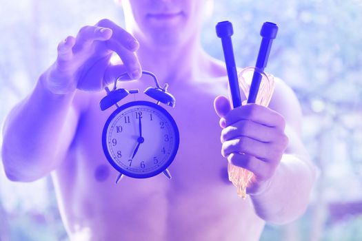 A man holding the rope and the clock. Time to start exercise