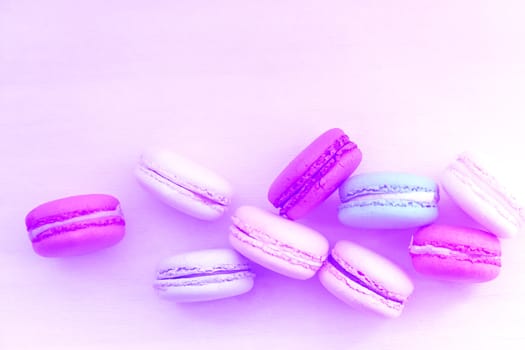 Macaroon. The bright colored rolls, cookies. The background substrate.