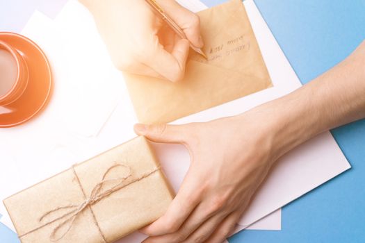 A man signs a gift. Mail. Card.