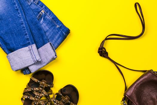 Sandals, bag, jeans on a colored background