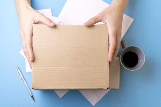 The man gives a parcel to the post office. Mail.