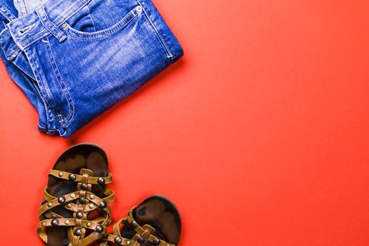 Sandals, bag, jeans on a colored background