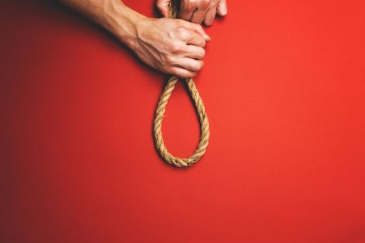 The man tightens the noose