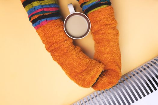 Girl hot near the heater in socks