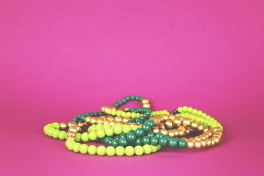 Green beads on a pink background