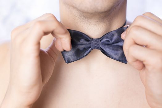 A man adjusts his tie