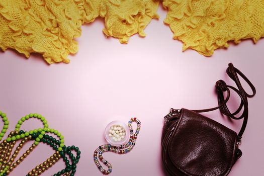 Women's accessories on a pink background.