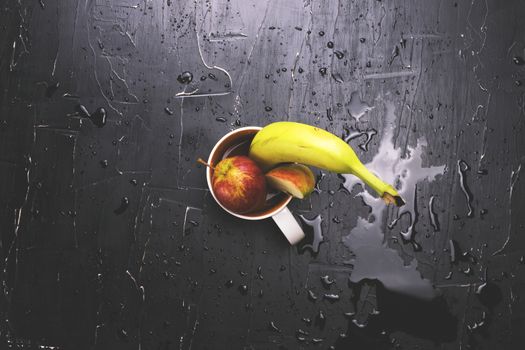 Fruit in a circle on a dark background. Concept of fresh juice and fruit tea.