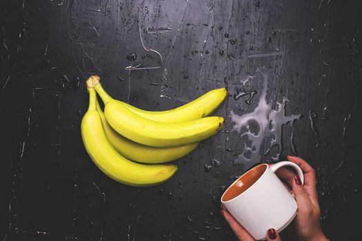 Bananas and a mug. The concept of fresh banana juice.