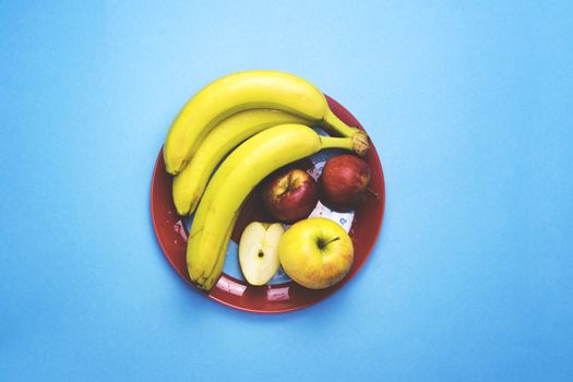 A plate of fruit on a color background