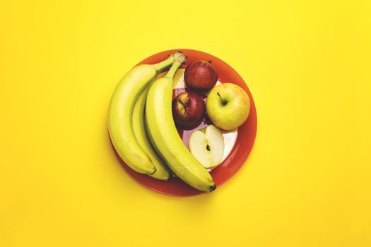A plate of fruit on a color background