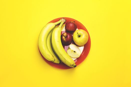 A plate of fruit on a color background