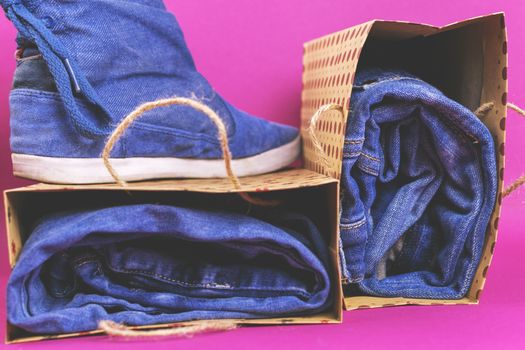 Denim clothes and shoes on a colored background. Vintage.