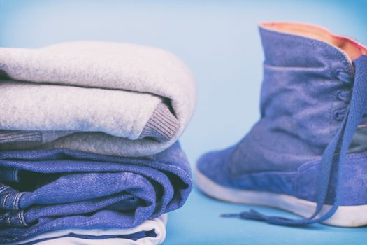 Denim clothes and shoes on a colored background. Vintage.