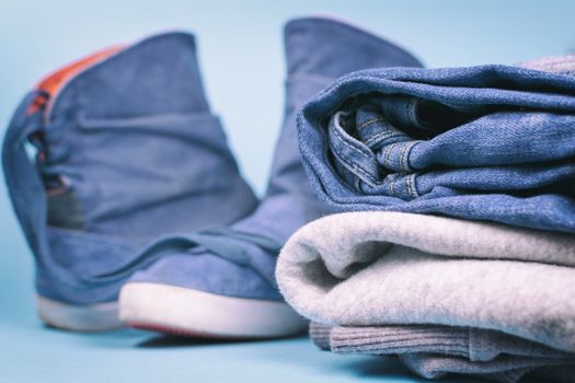 Denim clothes and shoes on a colored background. Vintage.