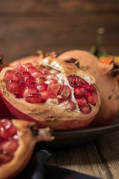 Pomegranate fruit on rustic table in vintage style.